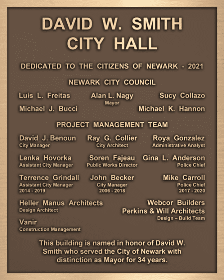 A classic bronze city hall dedication plaque.